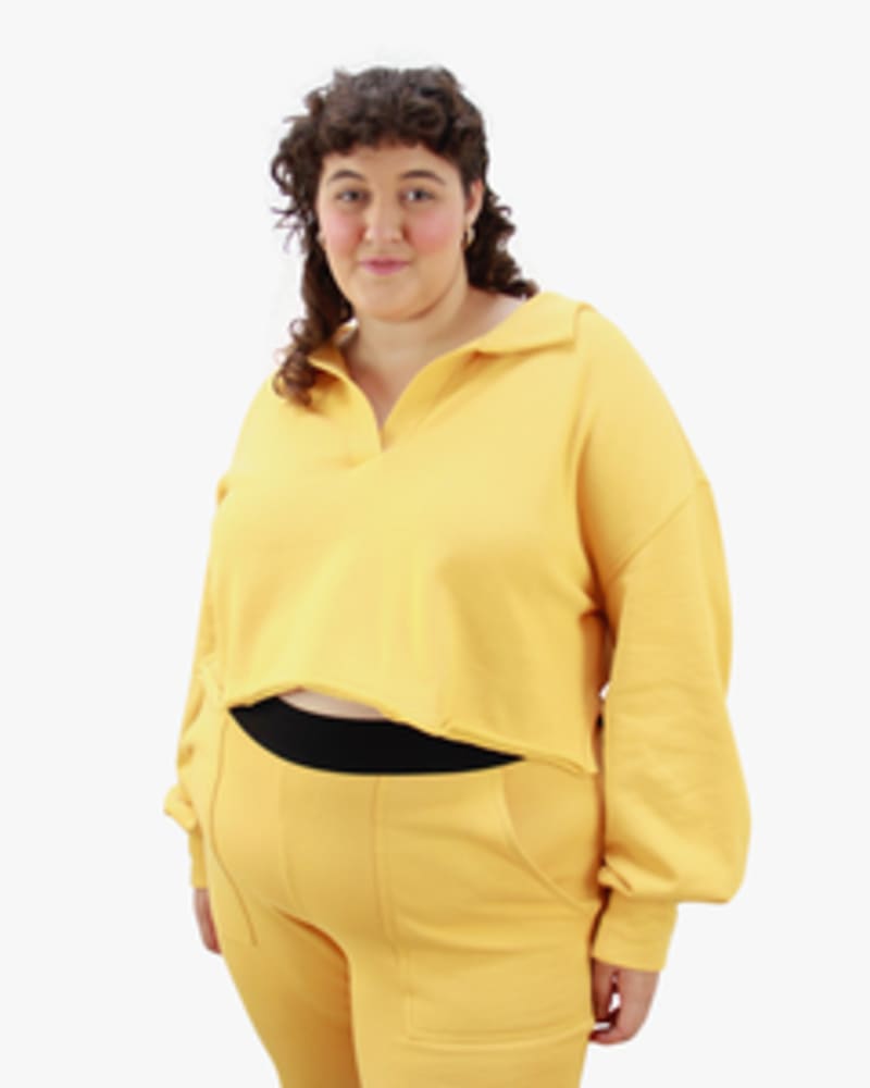 Front of a model wearing a size L Polo Sweatshirt in Marigold by Lovefool. | dia_product_style_image_id:249781